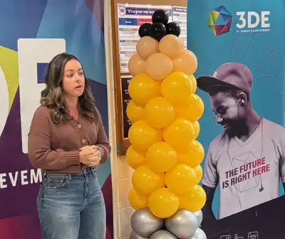 Image of a woman in brown sweater talking to a group